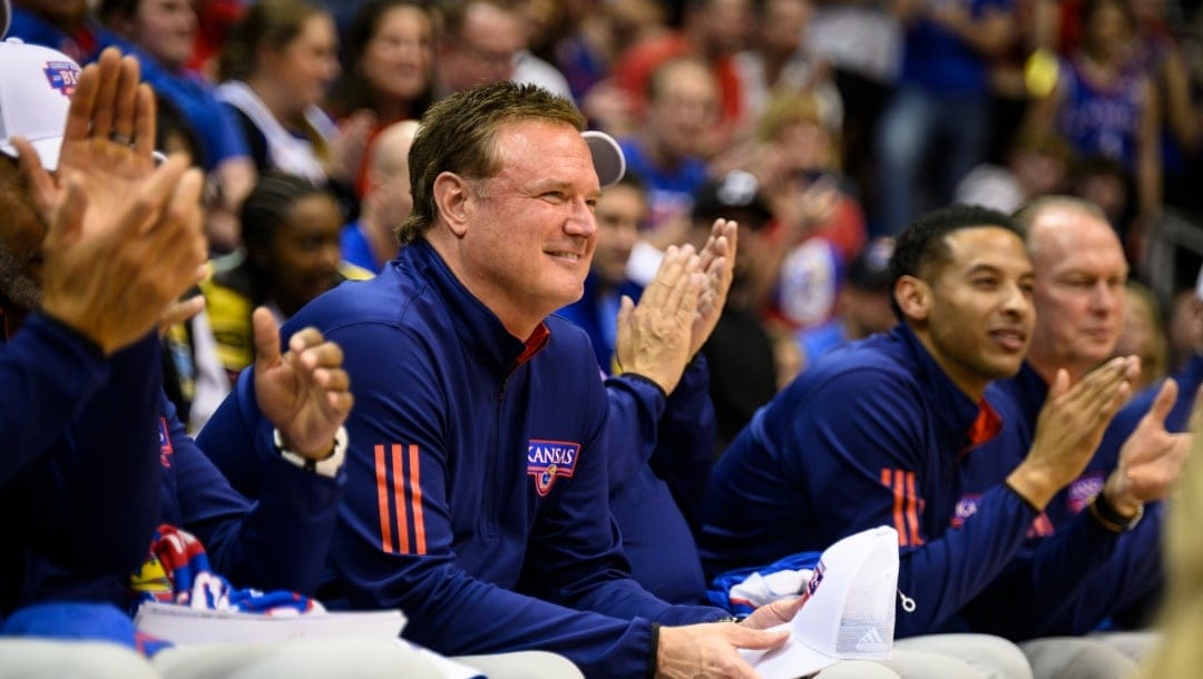 Kansas head coach Bill Self listens as Kevin McCullar Jr. gives a speech on Senior Night after they clinched a share of the Big 12 regular-season championship with a win over Texas Tech in an NCAA college basketball game in Lawrence, Kan., Tuesday, Feb. 28, 2023. (AP Photo/Reed Hoffmann