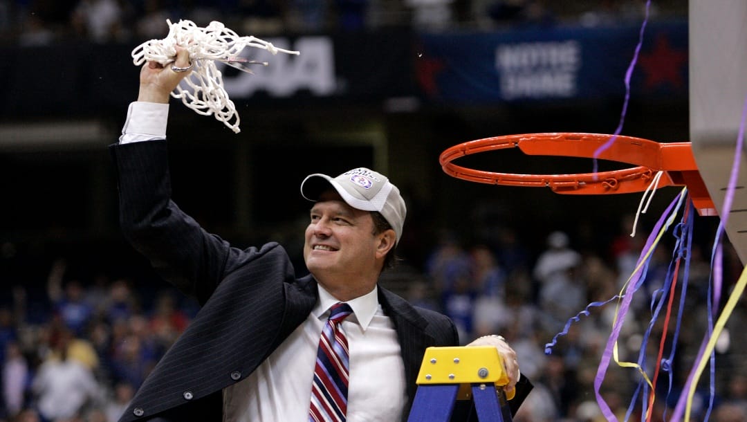 Kansas coach Bill Self cuts down the net after Kansas defeated Memphis 75-68 in OT to win the NCAA college basketball Final Four championship game, Monday, April 7, 2008, in San Antonio. (AP Photo/Mark Humphrey)