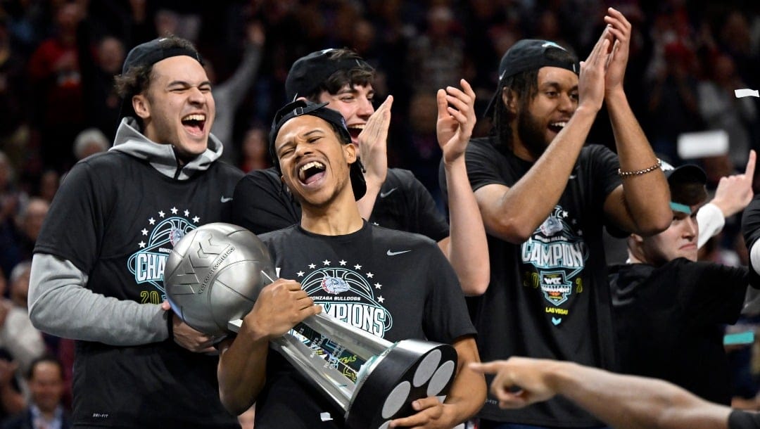 Gonzaga guard Rasir Bolton, second left, celebrates with the championship trophy after the team defeated Saint Mary's in an NCAA college basketball game in the finals of the West Coast Conference men's tournament Tuesday, March 7, 2023, in Las Vegas. (AP Photo/David Becker)