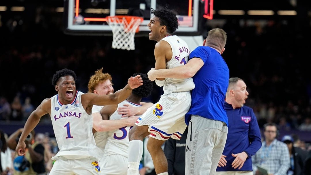 Kansas's Remy Martin, center, celebrates with teammates after their win against North Carolina in a college basketball game at the finals of the Men's Final Four NCAA tournament, Monday, April 4, 2022, in New Orleans. (AP Photo/Brynn Anderson)