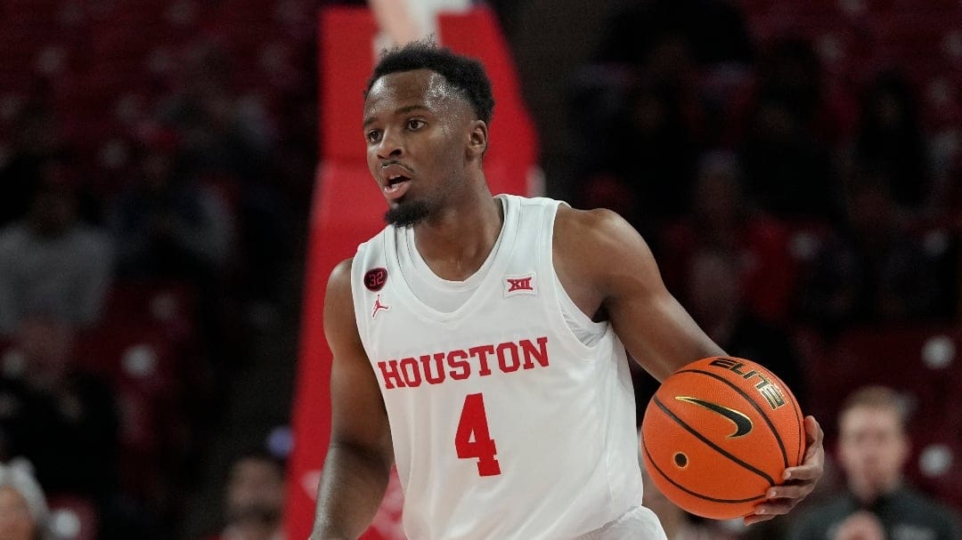 Houston's L.J. Cryer brings the ball up the court against Stetson during the first half of an NCAA college basketball game Monday, Nov. 13, 2023, in Houston. (AP Photo/David J. Phillip)