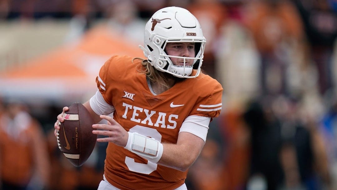 Texas quarterback Quinn Ewers (3) looks to throw against Baylor during the first half of an NCAA college football game in Austin, Texas, Friday, Nov. 25, 2022. (AP Photo/Eric Gay)
