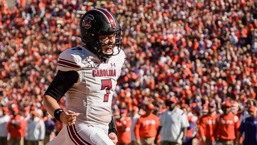 South Carolina quarterback Spencer Rattler celebrates after scoring a touchdown in the first half of an NCAA college football game against Clemson on Saturday, Nov. 26, 2022, in Clemson, S.C. (AP Photo/Jacob Kupferman)