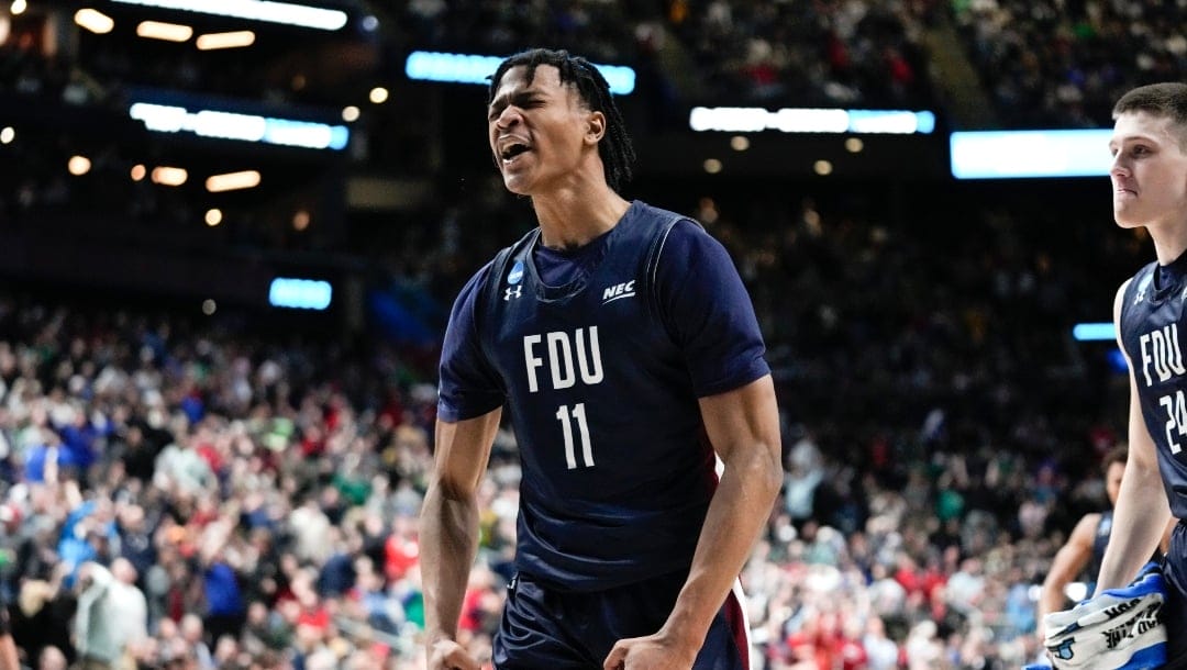 Fairleigh Dickinson forward Sean Moore (11) reacts to a basket against Purdue in the second half of a first-round college basketball game in the NCAA Tournament Friday, March 17, 2023, in Columbus, Ohio. (AP Photo/Paul Sancya)