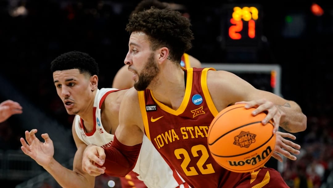 Iowa State's Gabe Kalscheur drives past Wisconsin's Johnny Davis during the first half of a second-round NCAA college basketball tournament game Sunday, March 20, 2022, in Milwaukee. (AP Photo/Morry Gash)