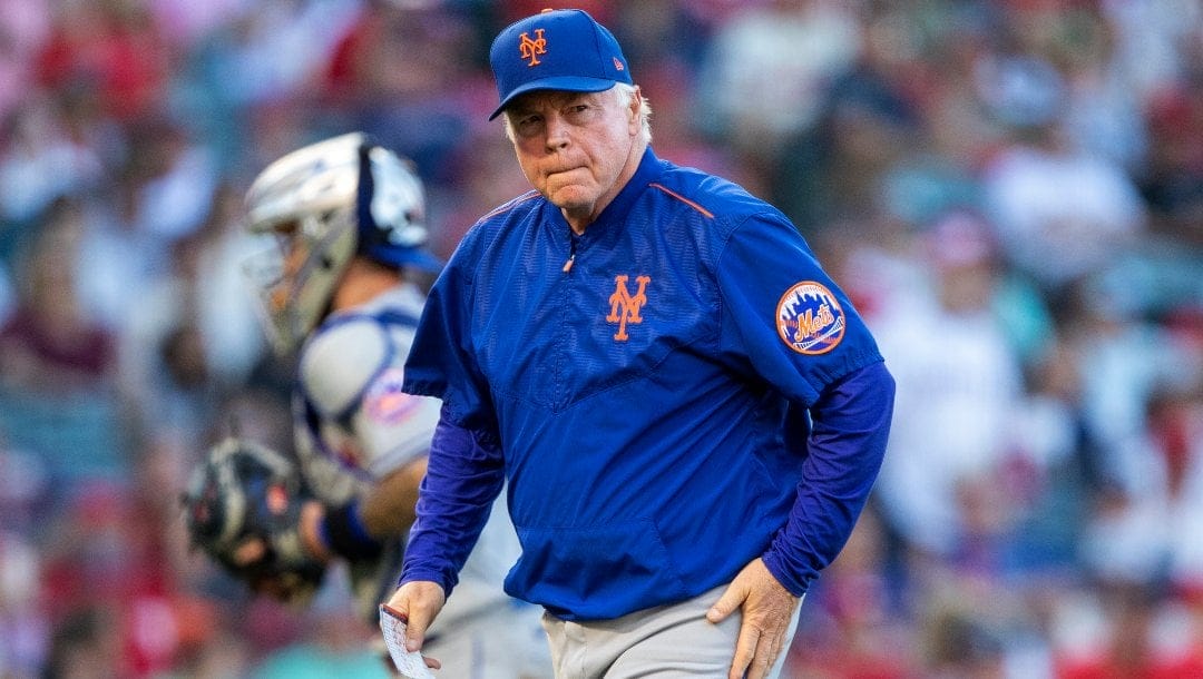 New York Mets manager Buck Showalter walks back to his durout after making a pitching change during the eighth inning of a baseball game against the Los Angeles Angels in Anaheim, Calif., Sunday, June 12, 2022.