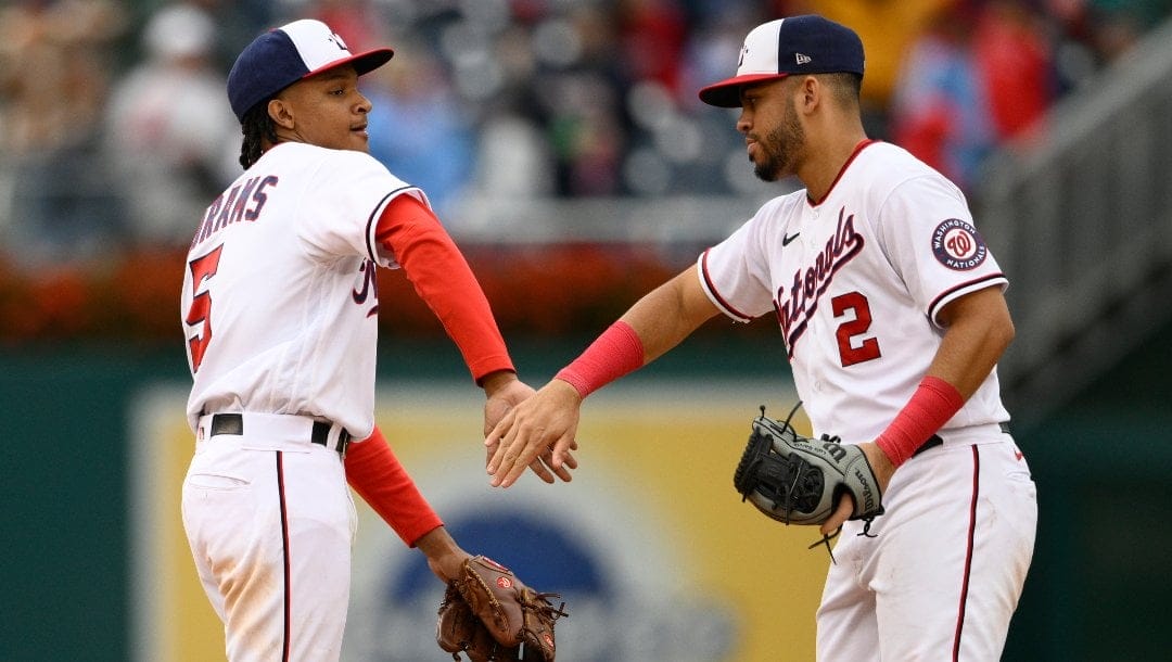 Washington Nationals' CJ Abrams (5) and Luis Garcia (2) celebrate after the first baseball game of a doubleheader against the Philadelphia Phillies, Saturday, Oct. 1, 2022, in Washington. The Nationals won 13-4.