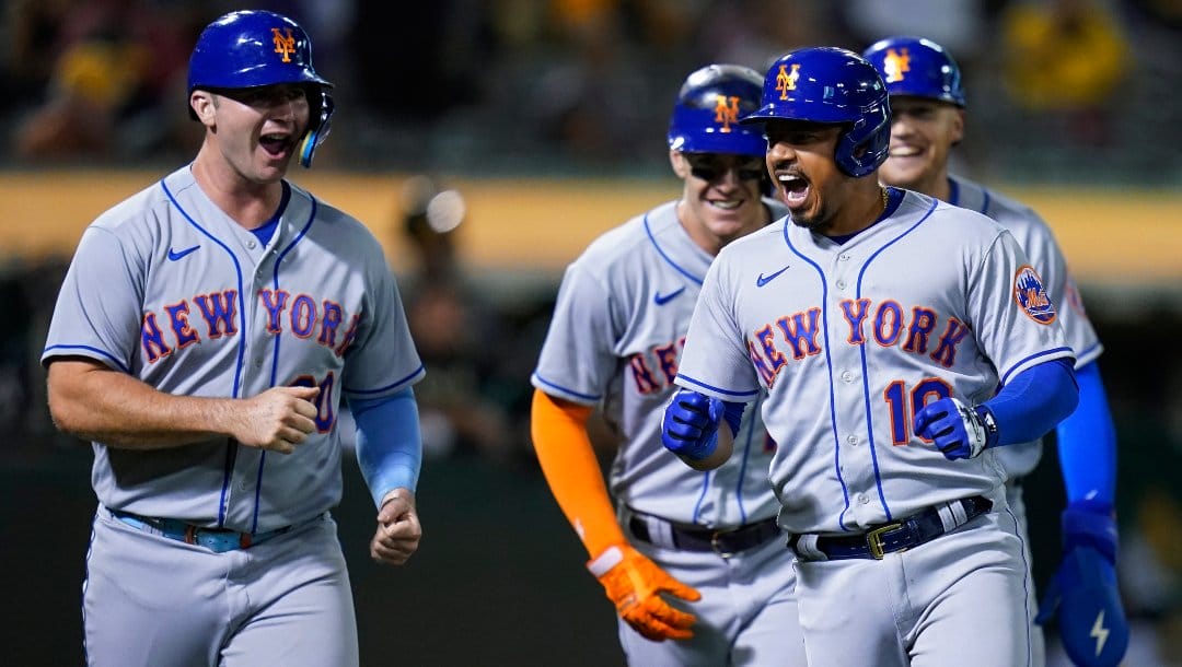 New York Mets' Eduardo Escobar, right, celebrates with teammates after hitting a grand slam against the Oakland Athletics during the fifth inning of a baseball game in Oakland, Calif., Friday, Sept. 23, 2022.