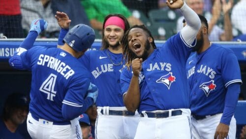 Toronto Blue Jays' George Springer (4) celebrates with Bo Bichette, center, and Vladimir Guerrero Jr., right, after hitting a home run during the second inning of a baseball game against the Toronto Blue Jays in Buffalo, N.Y., Friday, June 25, 2021.