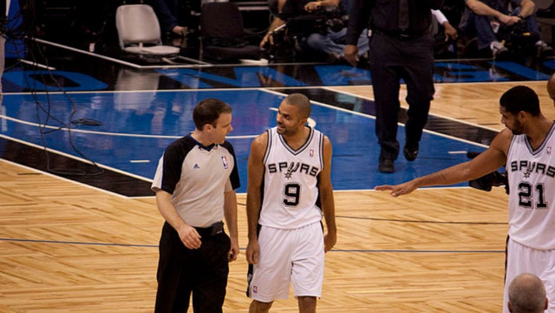 Tony Parker and Tim Duncan of the San Antonio Spurs talk to the referee during their game against the Orlando Magic in December 2010.