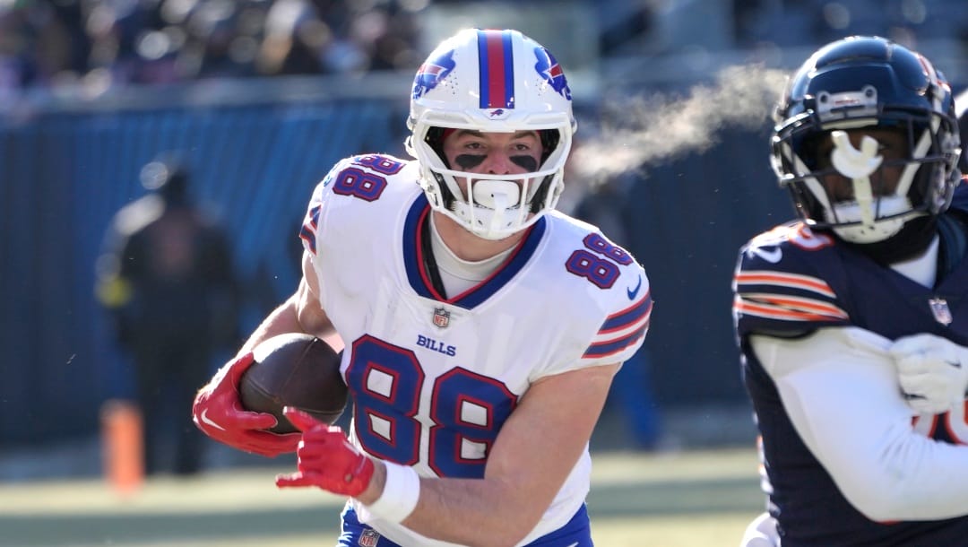 Buffalo Bills' Dawson Knox carries the ball during an NFL football game against the Chicago Bears Saturday, Dec. 24, 2022, in Chicago. The Bills won 35-13. (AP Photo/Charles Rex Arbogast)
