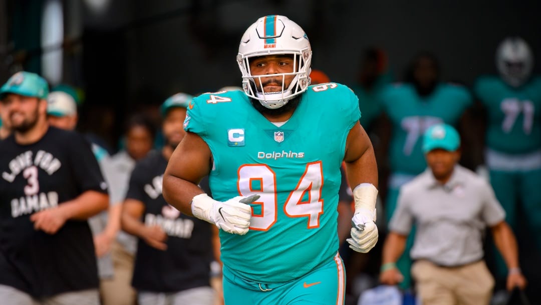 Miami Dolphins defensive tackle Christian Wilkins (94) runs onto the field before an NFL football game against the New York Jets, Sunday, Jan. 8, 2023, in Miami Gardens, Fla. (AP Photo/Doug Murray)