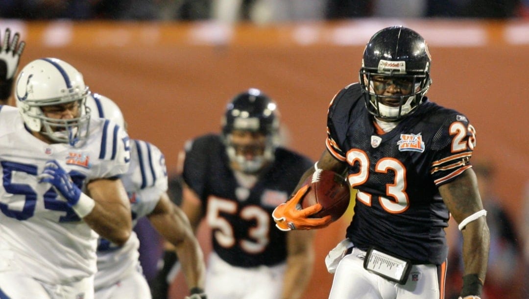 FILE - In this Feb. 4, 2007, file photo, Chicago Bears' Devin Hester (23) runs back the opening kickoff 92-yards for a touchdown in the Super Bowl XLI football game against the Indianapolis Colts at Dolphin Stadium in Miami. Hester, the all-purpose speedster who holds the NFL record for kick return touchdowns with 20, announced his retirement from the NFL, Tuesday, Dec. 12, 2017. (AP Photo/Alex Brandon, File)