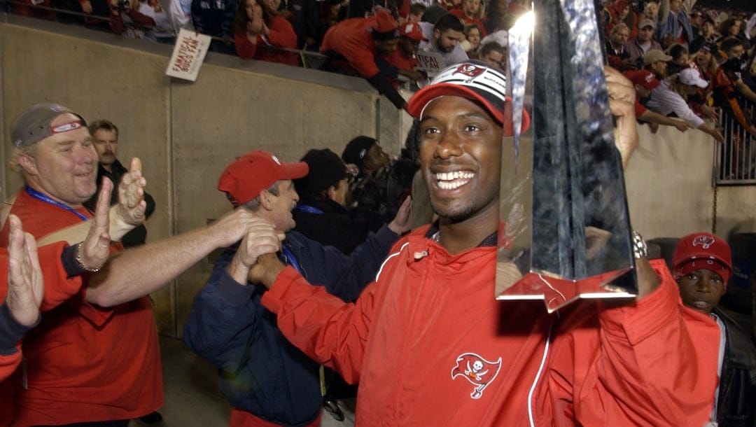 Tampa Bay Buccaneers' Dexter Jackson holds his Super Bowl MVP trophy as he high-fives fans during a victory celebration at Raymond James Stadium, Monday night, Jan. 27, 2003, in Tampa, Fla. (AP Photo/Scott Martin)