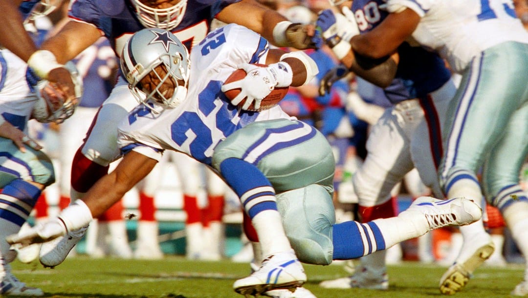FILE - Dallas Cowboys running back Emmitt Smith (22) picks up yardage under Buffalo Bills linebacker Cornelius Bennett during the first quarter of NFL football's Super Bowl XXVII in Pasadena, Calif., Jan. 31, 1993. (AP Photo/Rick Bowmer, File)