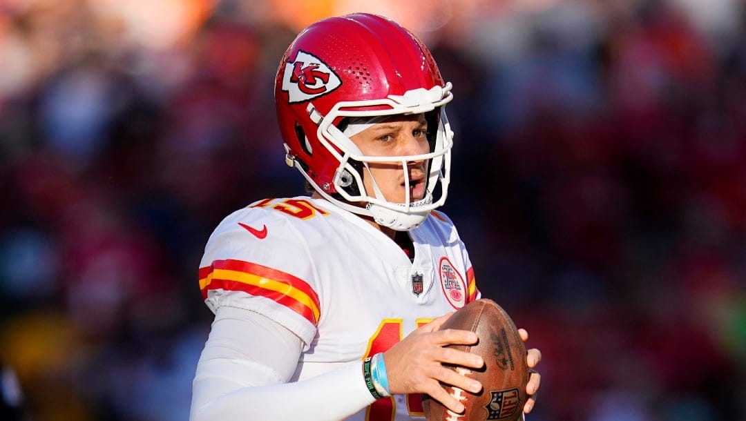 Kansas City Chiefs quarterback Patrick Mahomes (15) looks to pass against the Denver Broncos during the first half of an NFL football game, Sunday, Dec. 11, 2022, in Denver. (AP Photo/Jack Dempsey)