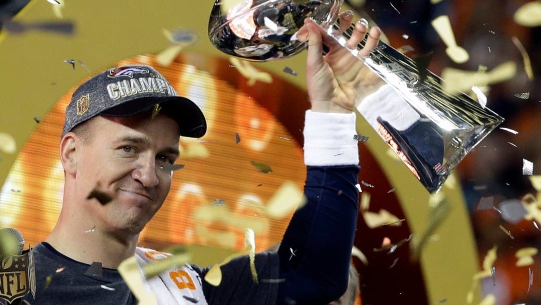 FILE - In this Feb. 7, 2016, file photo, Denver Broncos quarterback Peyton Manning holds up the Vince Lombardi Trophy after the Broncos defeated the Carolina Panthers 24-10 in NFL football's Super Bowl 50 in Santa Clara, Calif. Manning's legacy lives on at Empower Field at Mile High, where he will be honored Sunday, Oct. 31 2021, during pregame and halftime ceremonies for his inductions into the Pro Football Hall of Fame and the Broncos' Ring of Fame.Fame and the Broncos' Ring of Fame. (AP Photo/Julie Jacobson, File)