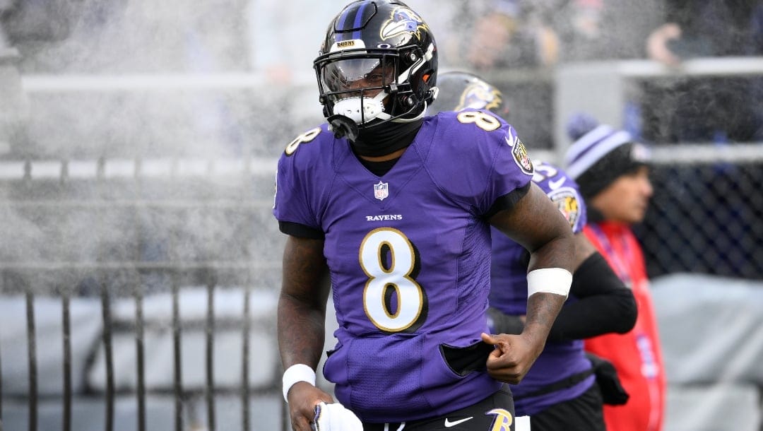 Baltimore Ravens quarterback Lamar Jackson (8) takes to the field