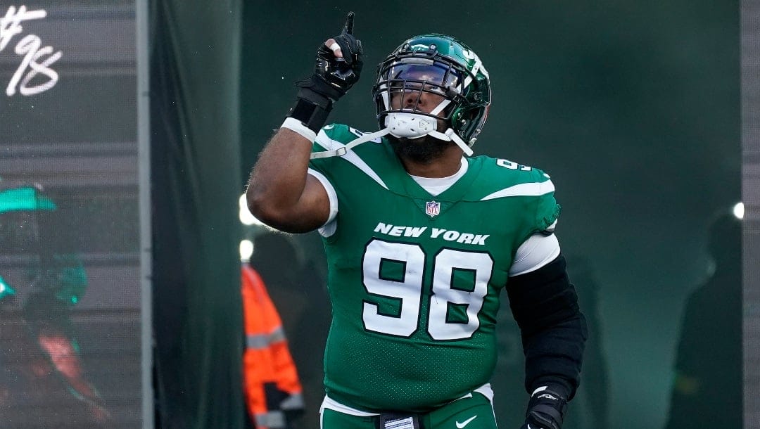 New York Jets defensive tackle Sheldon Rankins (98) runs onto the field during player introductions before playing against the Detroit Lions in an NFL football game, Sunday, Dec. 18, 2022, in East Rutherford, N.J. (AP Photo/Bryan Woolston)