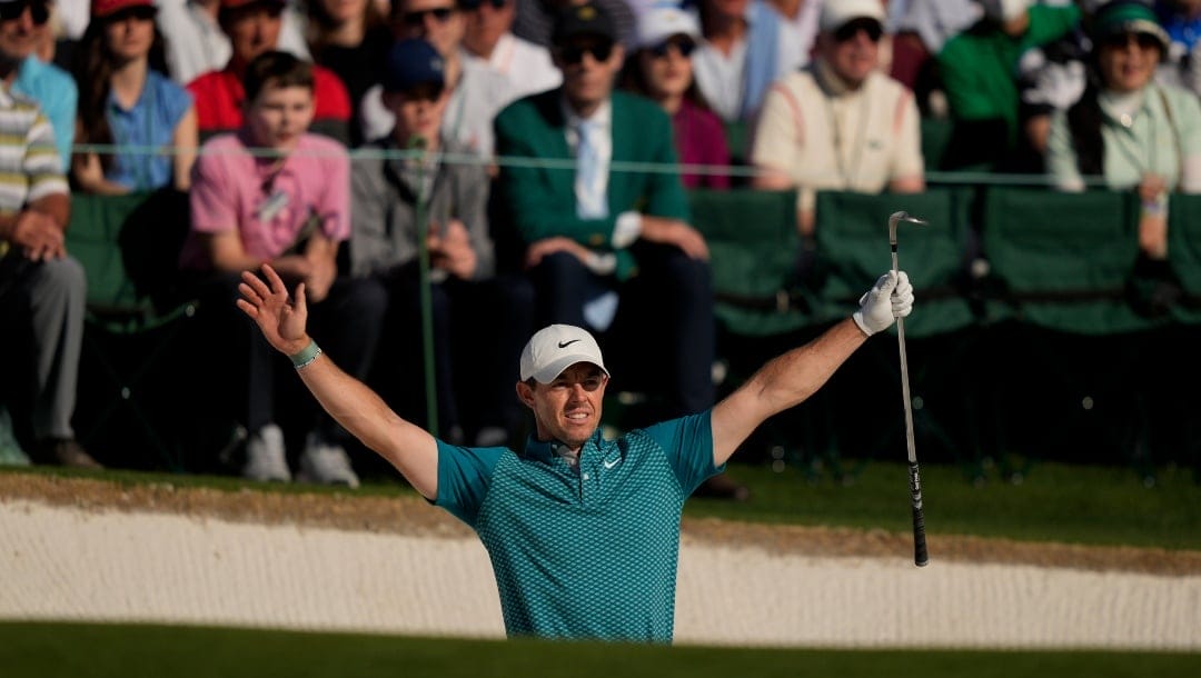 Rory McIlroy, of Northern Ireland, reacts after holing out from the bunker for a birdie during the final round at the Masters golf tournament on Sunday, April 10, 2022, in Augusta, Ga. (AP Photo/Matt Slocum)