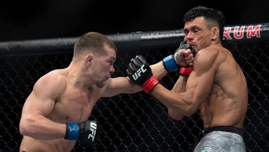 Petr Yan, left, lands a punch to Douglas Silva de Andrade's face during the second round of a bantamweight mixed martial arts bout.