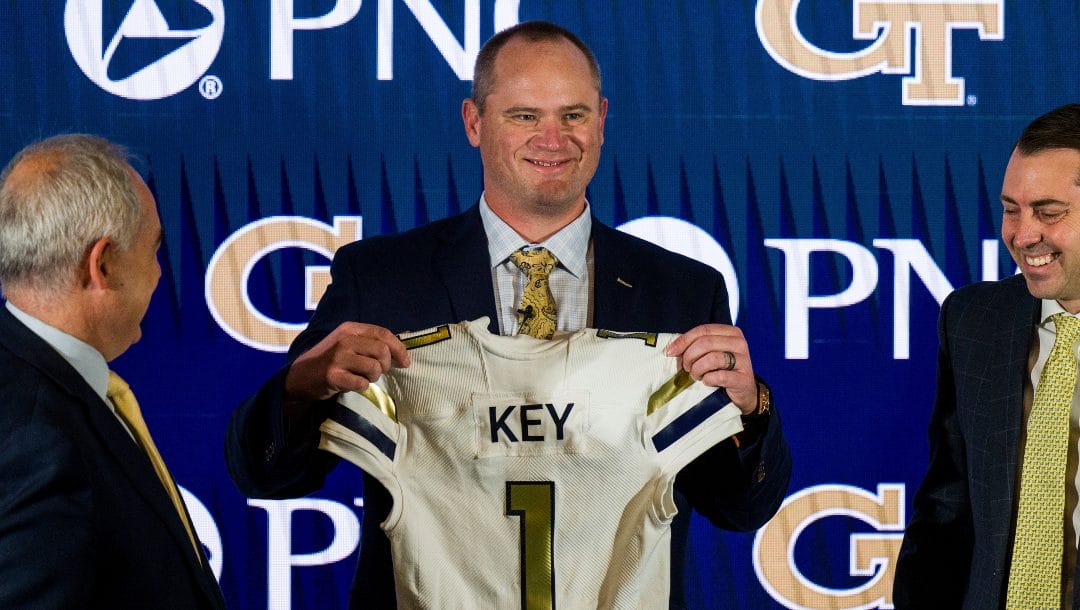 Newly hired Georgia Tech football coach Brent Key holds up a jersey during a news conference, Monday, Dec. 5, 2022, in Atlanta.
