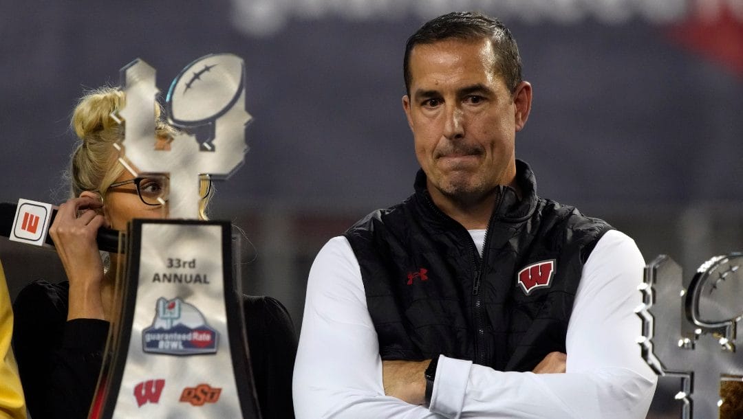 Wisconsin head coach Luke Fickell stands with the trophy after defeating Oklahoma State 24-17 in the Guaranteed Rate Bowl NCAA college football game Tuesday, Dec. 27, 2022, in Phoenix.