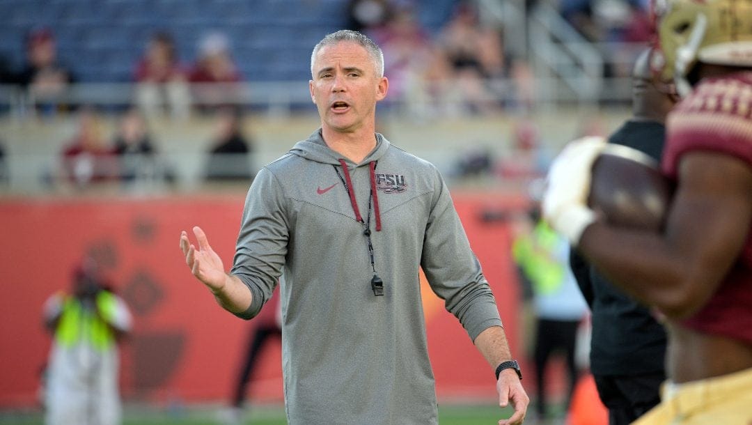 Florida State head coach Mike Norvell watches players warm up before the Cheez-It Bowl NCAA college football game against Oklahoma, Thursday, Dec. 29, 2022, in Orlando, Fla.