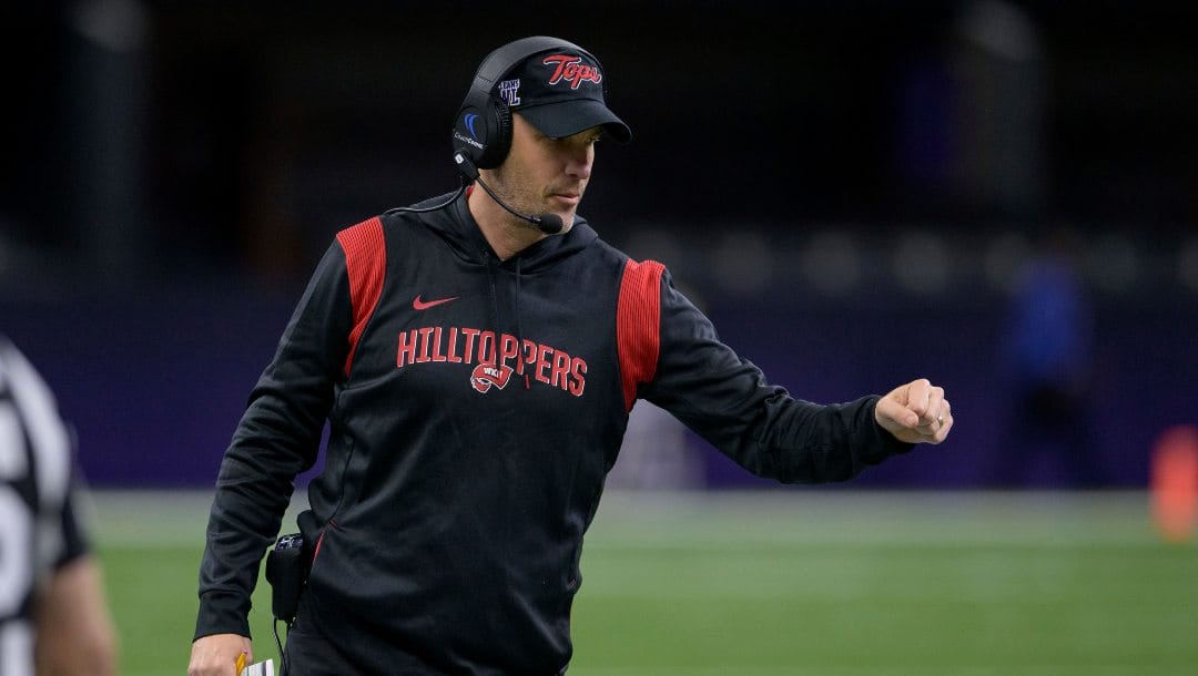 Western Kentucky head coach Tyson Helton fist bumps his players during the New Orleans Bowl NCAA football game against South Alabama in New Orleans, Wednesday, Dec. 21, 2022.