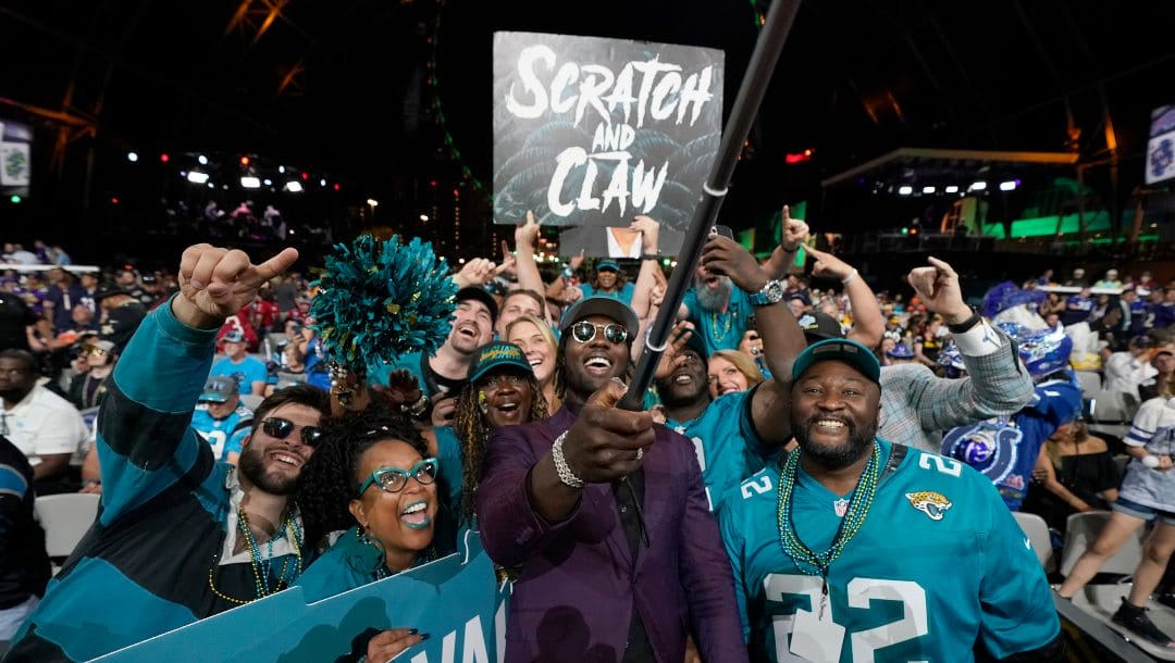 Utah linebacker Devin Lloyd celebrates with fans after he was chosen by the Jacksonville Jaguars with the 27th pick at the 2022 NFL Draft, Thursday, April 28, 2022, in Las Vegas.