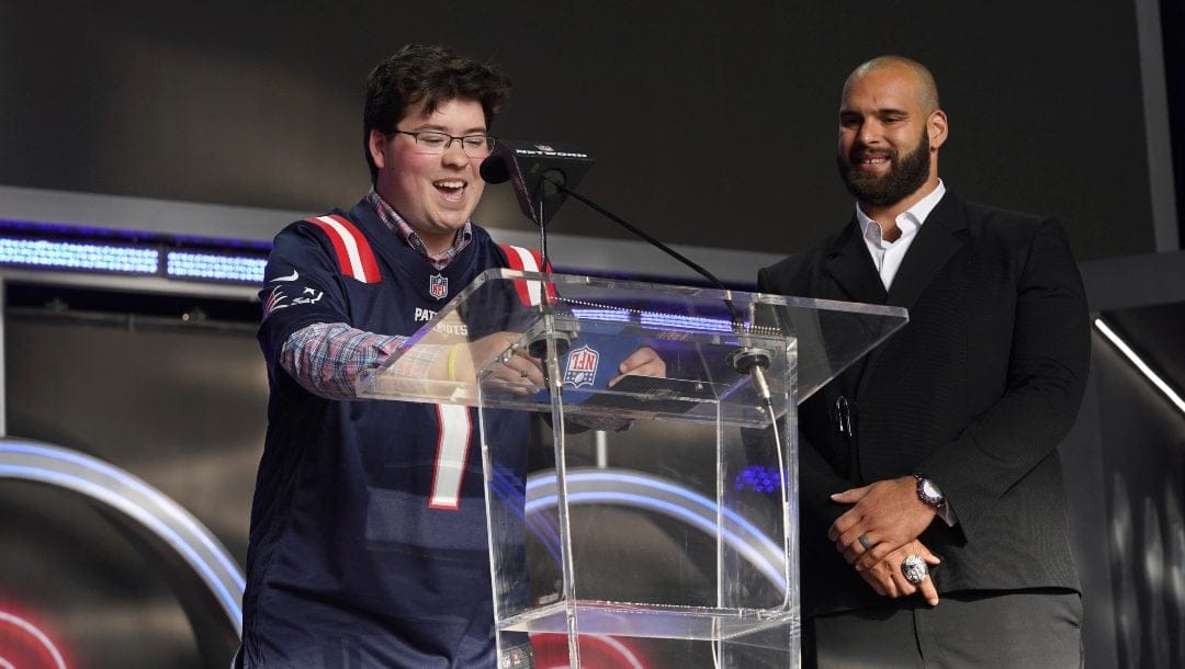 Ben Lepper of Make-A-Wish, left and Lawrence Guy announce the New England Patriots 50th pick during the 2022 NFL Draft on Friday, April 29, 2022, in Las Vegas.