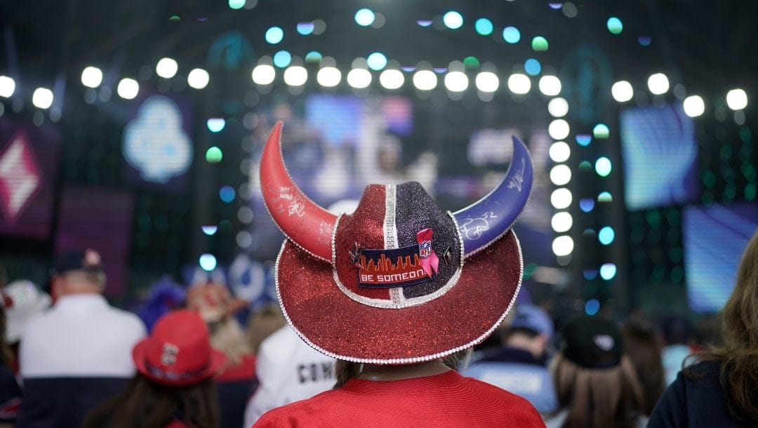 A Houston Texans fan watches the stage before the second round of the NFL football draft Friday, April 29, 2022, in Las Vegas.