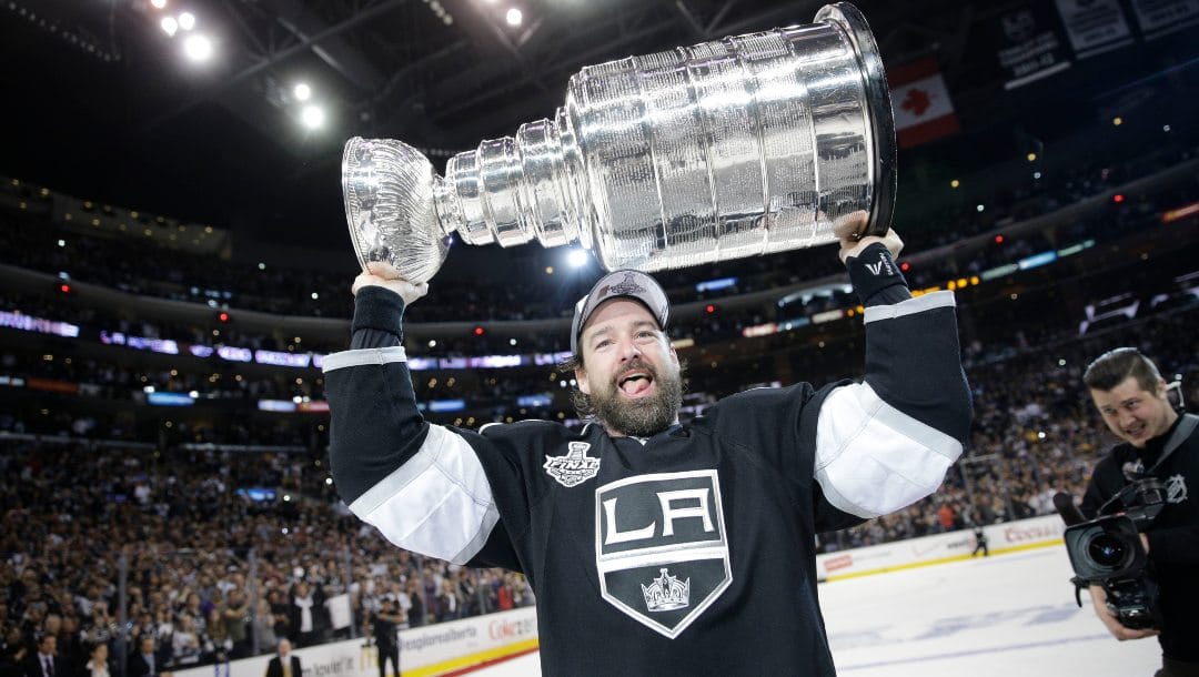Los Angeles Kings right wing Justin Williams, of Slovenia, carries the Stanley Cup after defeating the New York Rangers in Game 5 of the NHL Stanley Cup Final series, June 13, 2014, in Los Angeles.
