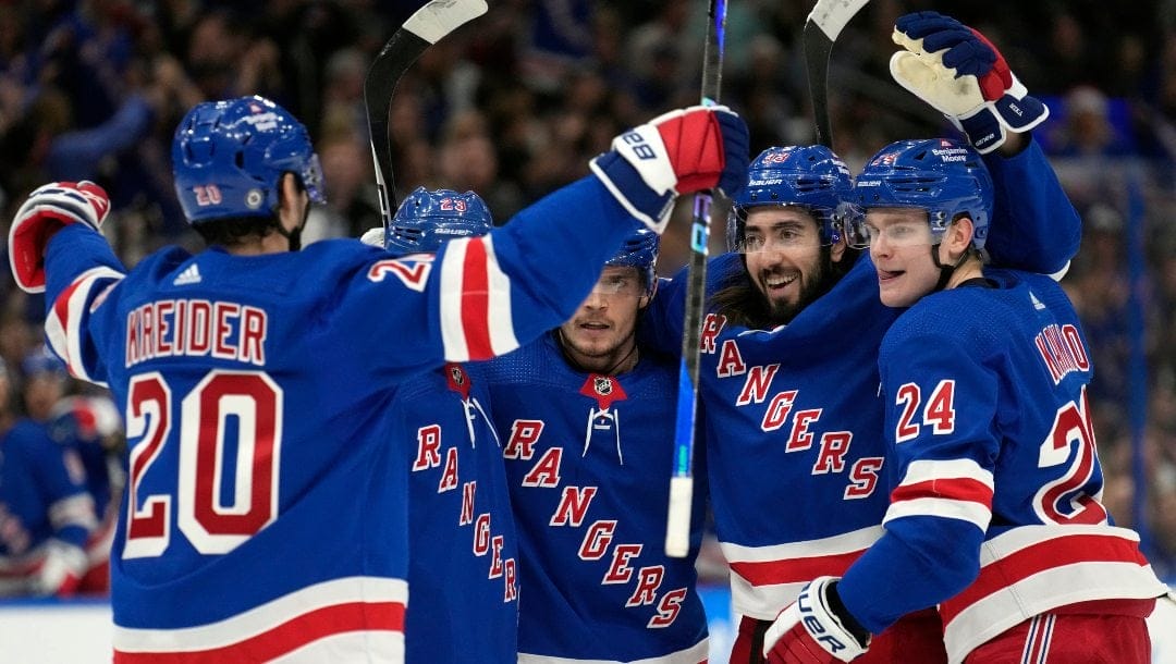 New York Rangers center Mika Zibanejad (93) celebrates his goal against the Tampa Bay Lightning with right wing Kaapo Kakko (24) and left wing Chris Kreider (20) during the first period of an NHL hockey game Thursday, Dec. 29, 2022, in Tampa, Fla.