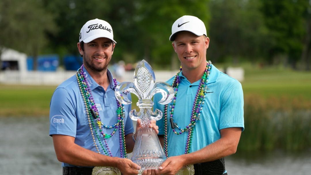 Davis Riley, left, and teammate Nick Hardy hold their trophy after winning the PGA Zurich Classic golf tournament at TPC Louisiana in Avondale, La., Sunday, April 23, 2023.