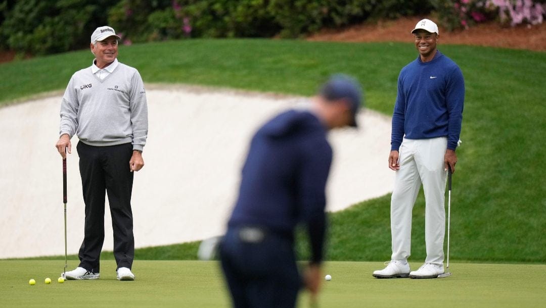 Fred Couples, left, and Tiger Woods watch Rory McIlroy, of Northern Ireland, putt on the 13th green during a practice for the Masters golf tournament at Augusta National Golf Club, Monday, April 3, 2023, in Augusta, Ga.