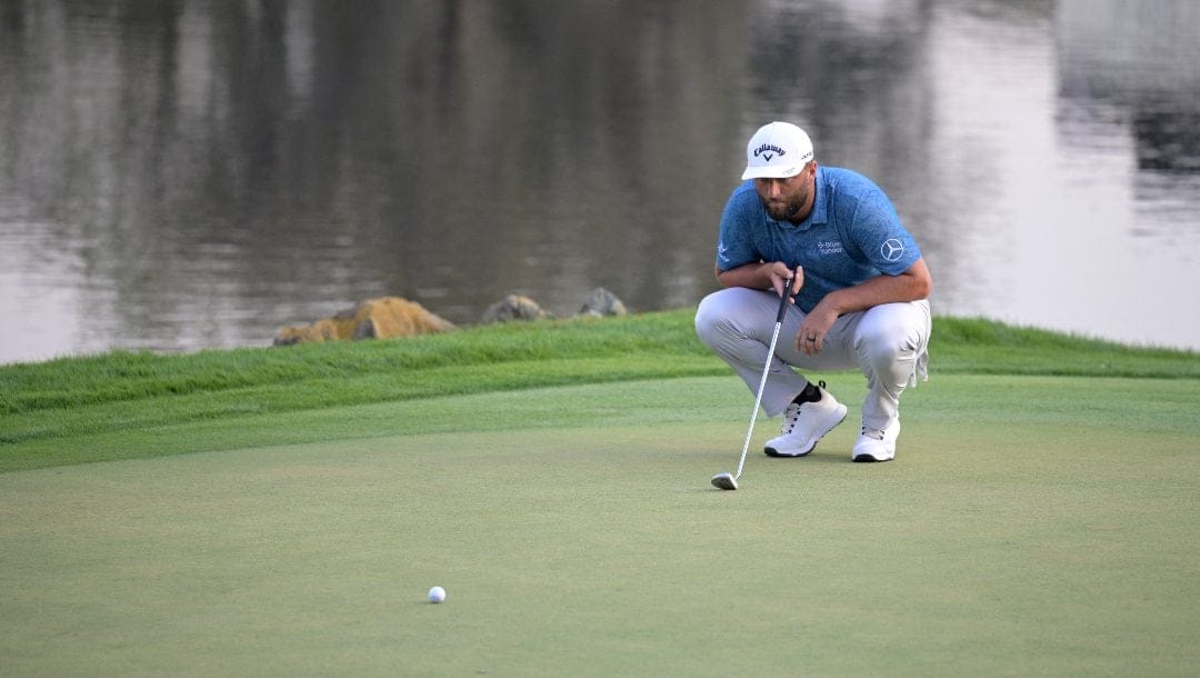 Jon Rahm, of Spain, lines up his putt on the 18th green during the first round of the Arnold Palmer Invitational golf tournament, Thursday, March 2, 2023, in Orlando, Fla.