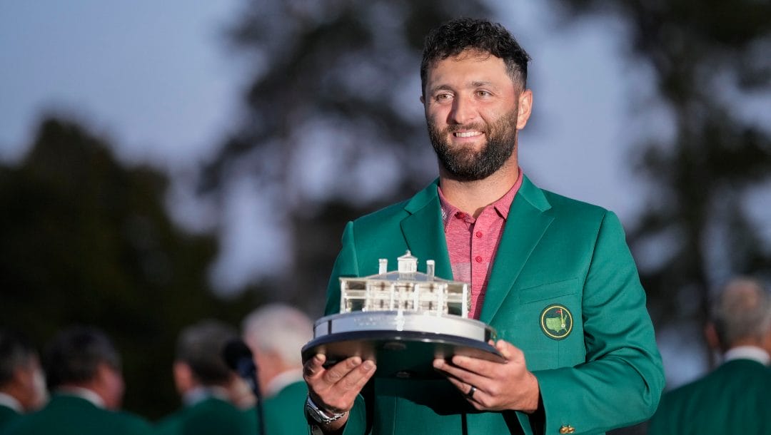 Jon Rahm, of Spain, holds up the trophy after winning the Masters golf tournament at Augusta National Golf Club on Sunday, April 9, 2023, in Augusta, Ga.