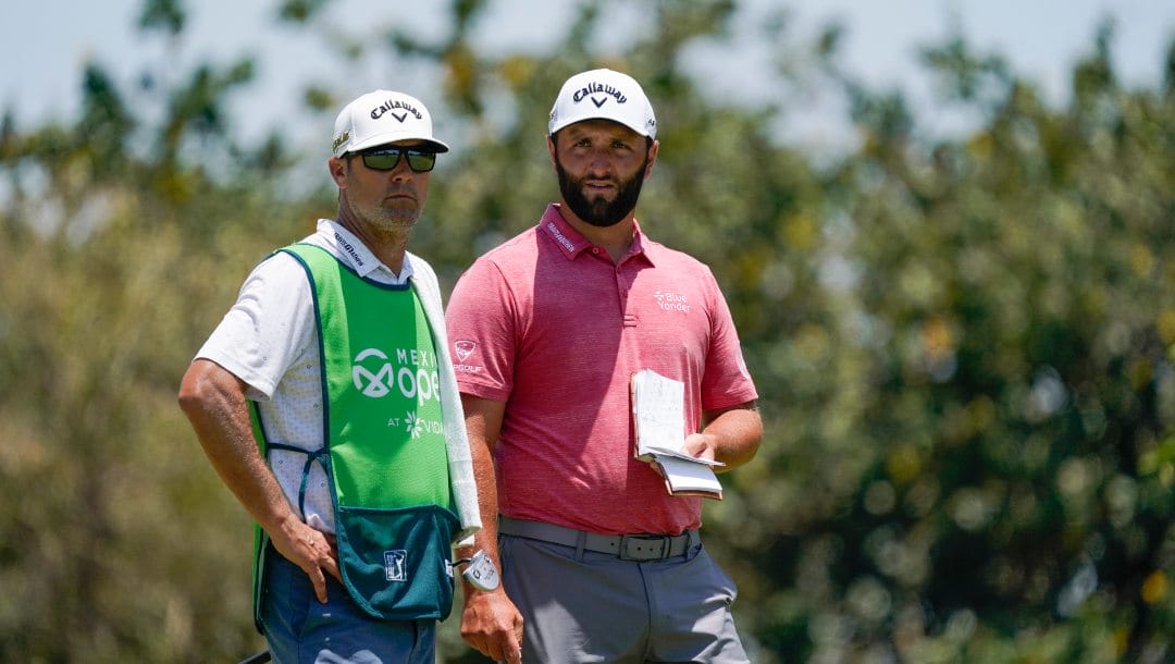 Jon Rahm, of Spain, and his caddie stand on the sixth hole during the final round of the Mexico Open at Vidanta in Puerto Vallarta, Mexico, Sunday, May 1, 2022.