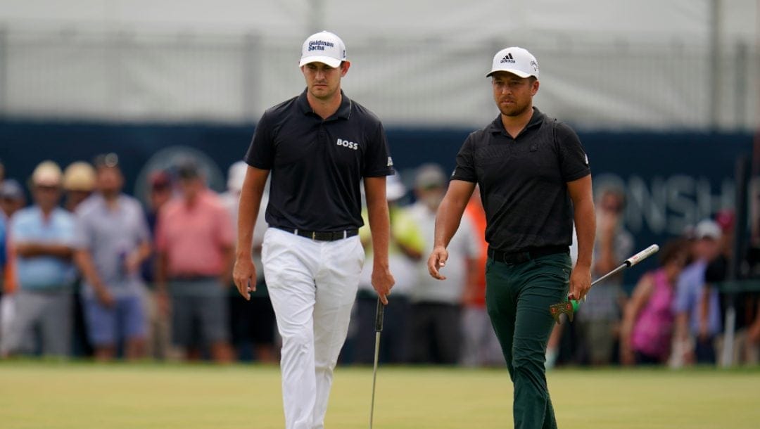Patrick Cantlay, left, and Xander Schauffele walk on the first green during the final round of the BMW Championship golf tournament at Wilmington Country Club, Sunday, Aug. 21, 2022, in Wilmington, Del.