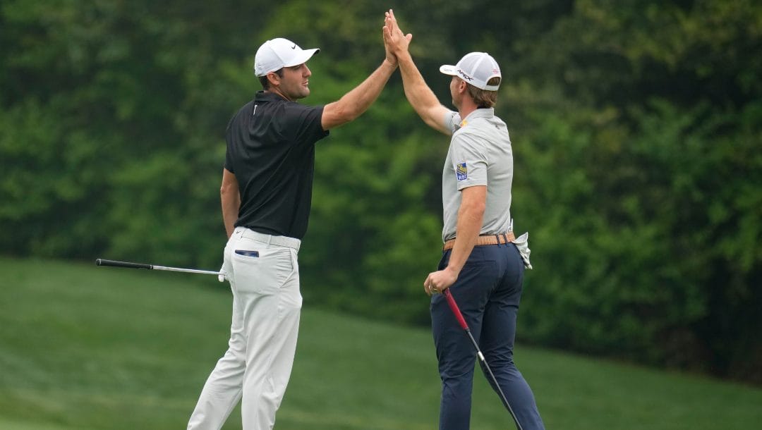 Sam Burns and Scottie Scheffler react on the 11th green during a practice for the Masters golf tournament at Augusta National Golf Club, Tuesday, April 4, 2023, in Augusta, Ga.