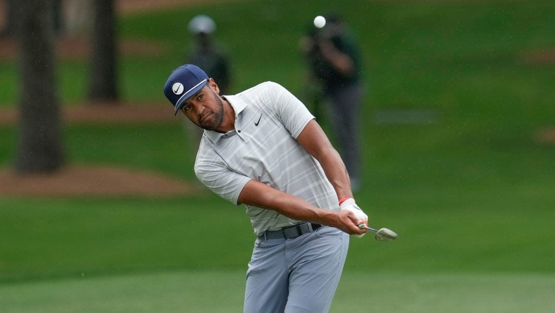 Tony Finau chips to the green on the seventh hole during the first round of the Masters golf tournament at Augusta National Golf Club on Thursday, April 6, 2023, in Augusta, Ga.
