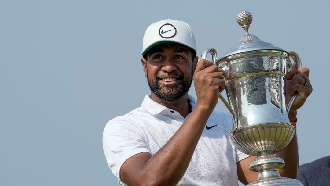 Tony Finau of the United States holds the championship trophy after his victory in the final round of the Mexico Open golf tournament in Puerto Vallarta, Mexico, Sunday, April 30, 2023.