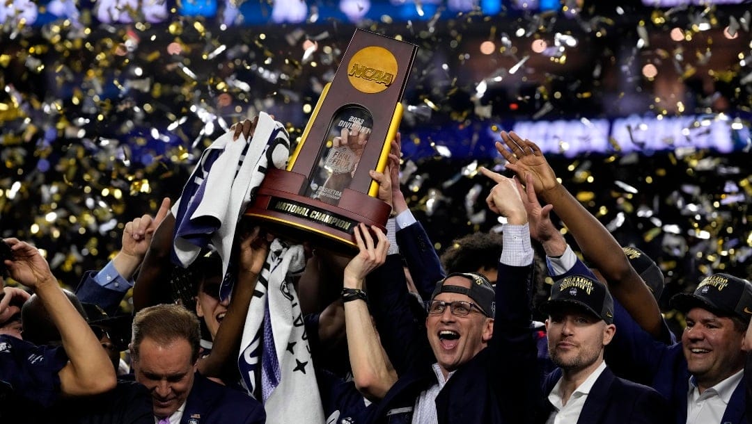 Connecticut head coach Dan Hurley celebrates with the trophy after their win against San Diego State during the men's national championship college basketball game in the NCAA Tournament on Monday, April 3, 2023, in Houston. (AP Photo/David J. Phillip)