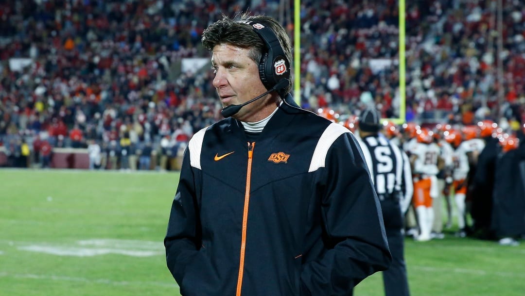 Oklahoma State head coach Mike Gundy stands on the sideline during the second half of an NCAA college football game against Oklahoma on Saturday, Nov. 19, 2022, in Norman, Okla. (AP Photo/Alonzo Adams)