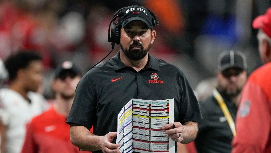 Ohio State head coach Ryan Day walks the sidelines during the first half of the Peach Bowl NCAA college football semifinal playoff game against Georgia, Saturday, Dec. 31, 2022, in Atlanta. (AP Photo/John Bazemore)
