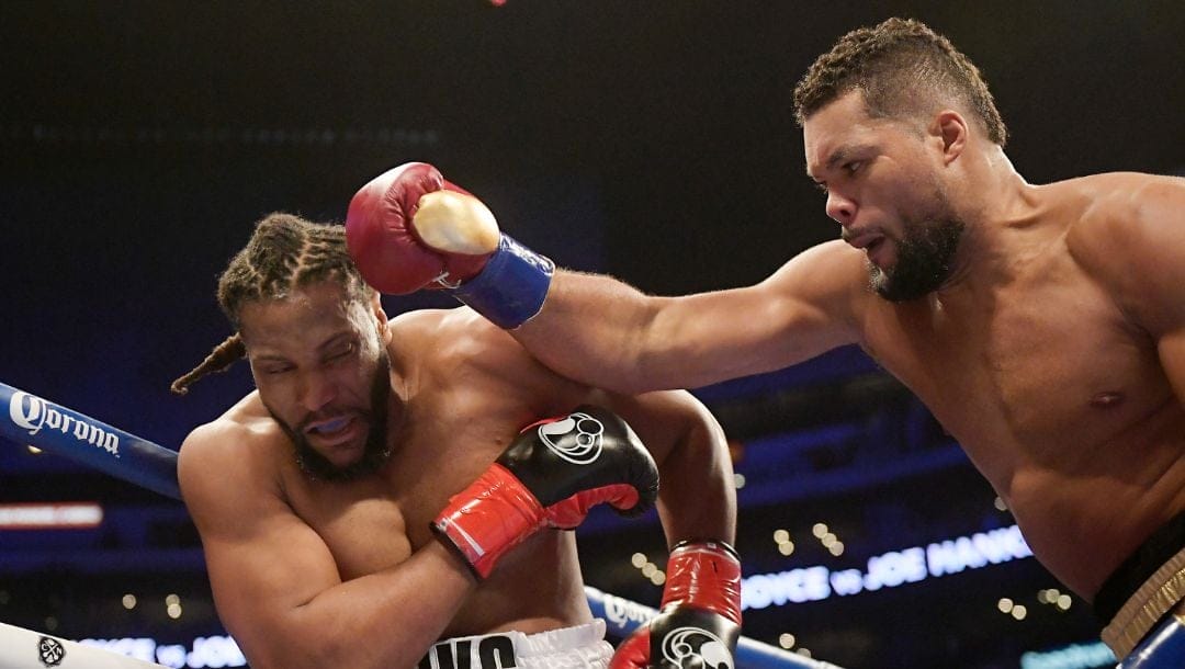 Joe Joyce, right, of England, connects with Joe Hanks during a WBA continental heavyweight bout Saturday, Dec. 1, 2018.