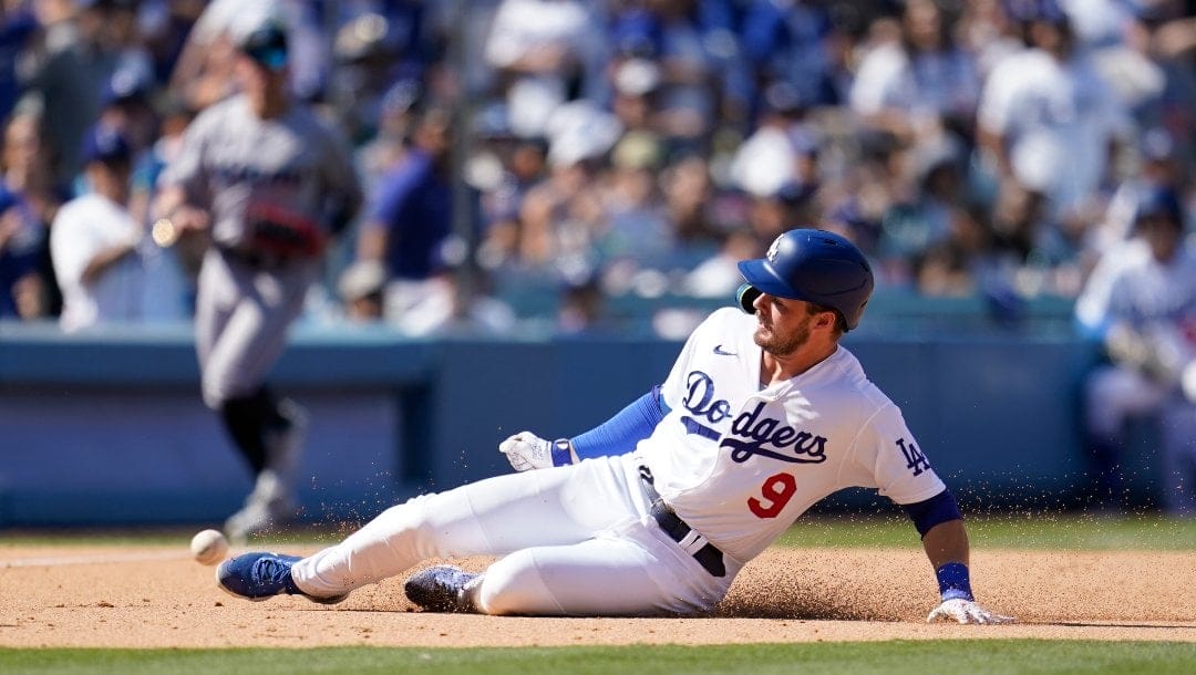Los Angeles Dodgers' Gavin Lux slides into third base as he tries for a triple during a baseball game against the Miami Marlins Sunday, Aug. 21, 2022, in Los Angeles. Lux was tagged out at third base.