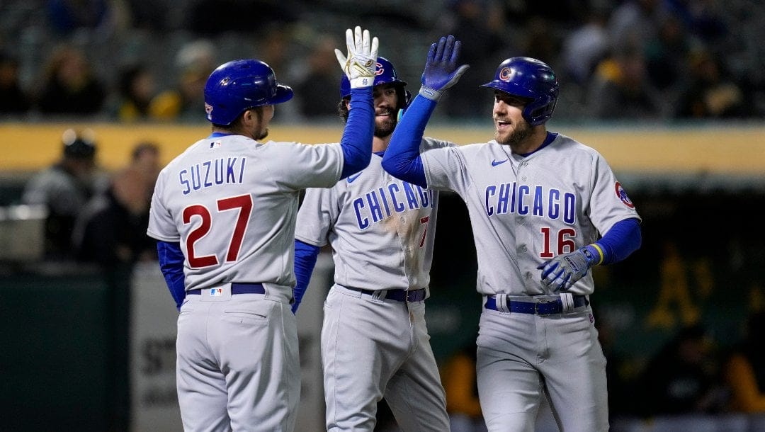 Chicago Cubs' Patrick Wisdom, right, celebrates with Seiya Suzuki, left, and Dansby Swanson after hitting a three-run home run against the Oakland Athletics during the eighth inning of a baseball game in Oakland, Calif., Monday, April 17, 2023.