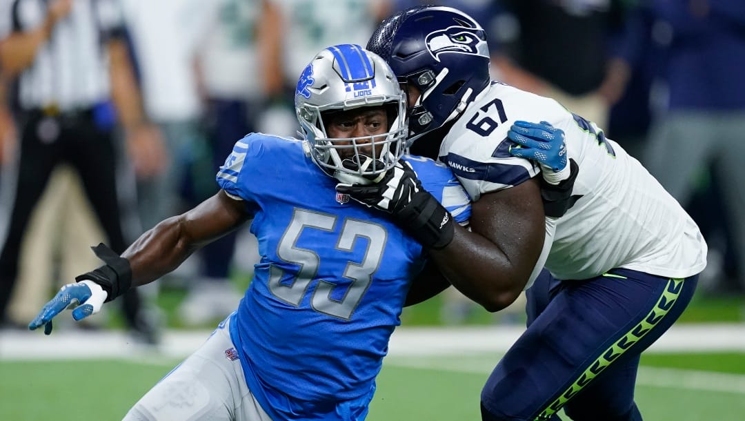 Detroit Lions linebacker Charles Harris (53) rushes against Seattle Seahawks offensive tackle Charles Cross (67) during an NFL football game in Detroit, Monday, Oct. 3, 2022. (AP Photo/Paul Sancya)